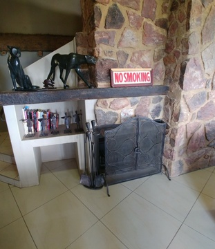 Blue Sky Lodge - Big stone fireplace in lounge. 2 of the bedrooms also have private fireplaces